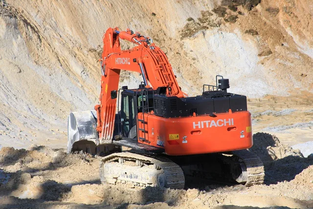 excavator, red, construction machine, machine, chain excavator, equipment, work machine, tool, construction vehicle, shovel. Contractors Equipment Insurance vs General Liability: Which One Pays for a Stolen Excavator?